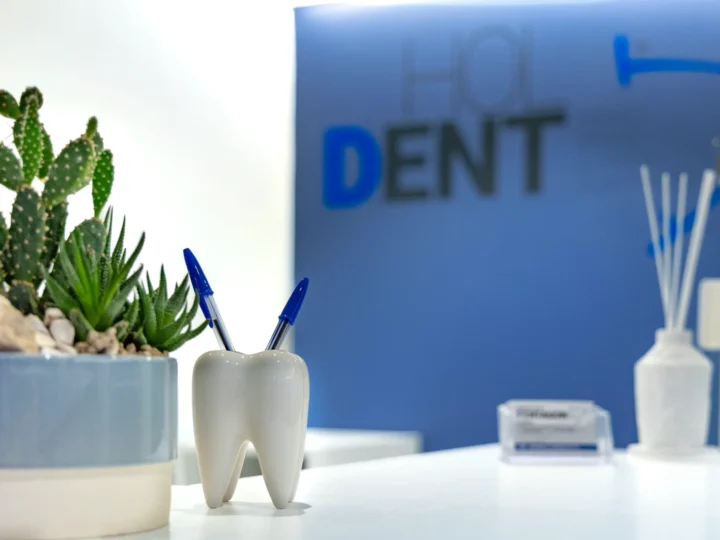 Dettaglio del banco reception con portaspazzolini a forma di dente — Clinica HolDent