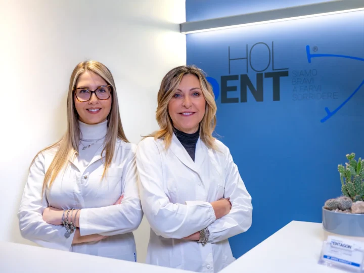 Due professioniste del team al banco reception — Clinica HolDent